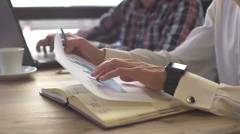 Two colleagues discussing data working and tablet, laptop with on on Stock Footage 67566572