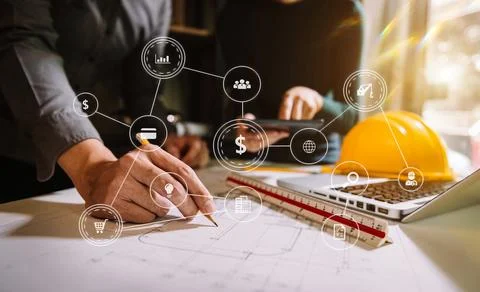 Two colleagues discussing data working and tablet, laptop with on on archit.. Stock Photos
