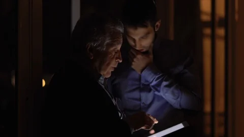 Two colleagues discussing at night on the office Stock Footage 88828778