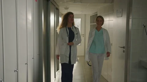 Two colleagues of doctors in the locker room after work Stock Footage 224061583