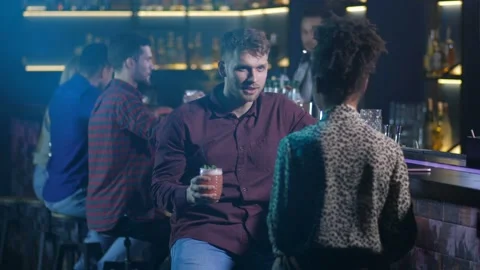 Two colleagues drinking at bar after work Stock Footage 105537401