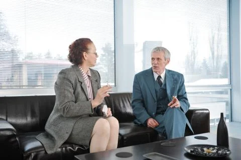 Two colleagues having a break during business meeting with cigarette Stock Photos