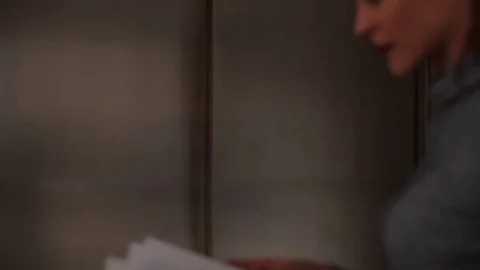 Two colleagues meeting in elevator  動画素材 75376398