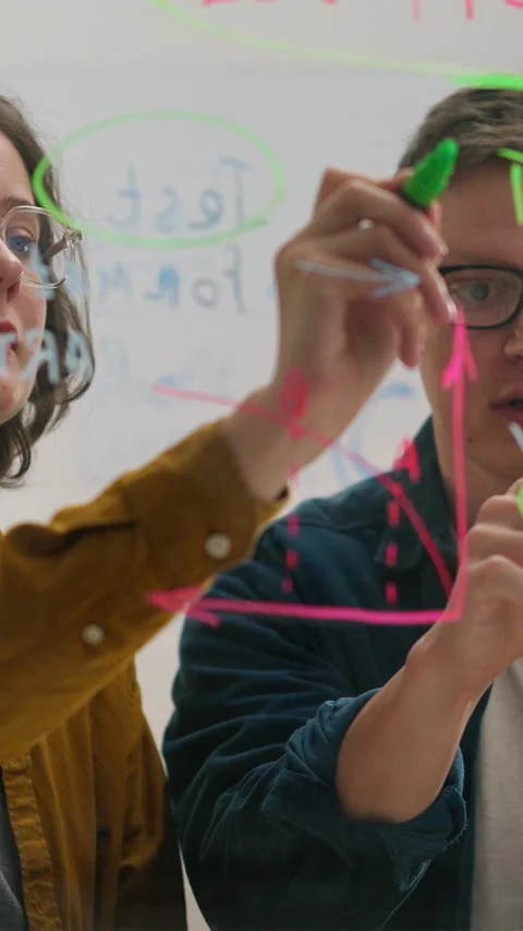 Two colleagues in modern office discuss business ideas with experienced work Stock Footage 341284971