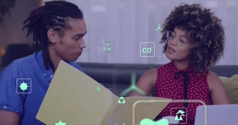 Two colleagues opening yellow folder, green icons appearing and expanding while Stock Footage 330237459