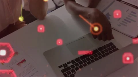 Two colleagues pointing at laptop and touching charts, causing animated red Stock Footage 333965583