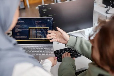 Two Colleagues Reviewing Code in IT Development Office Foto stock