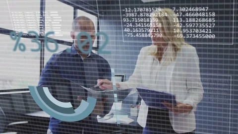 Two colleagues reviewing documents, animated data panels appearing while Stock Footage 332981945