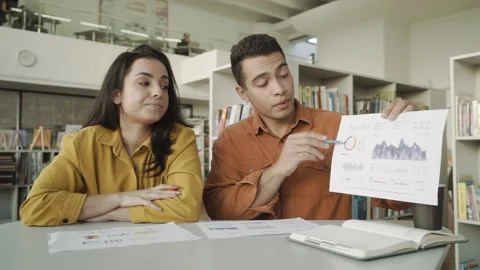 Two colleagues s talking by video call showing infographic statistics, mixed Stock Footage 146543125