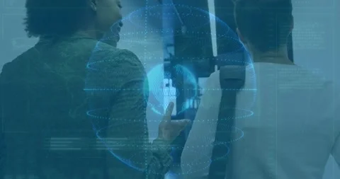 Two colleagues showing data points on interface in tech office, with hologram Stock Footage 329369231