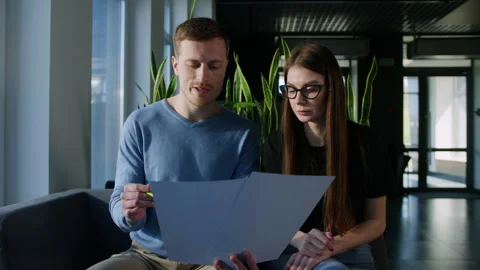 Two colleagues study the company's development schedules in the office Stock Footage 246050675