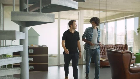 Two colleagues talking in modern office space Stock Footage 144992128