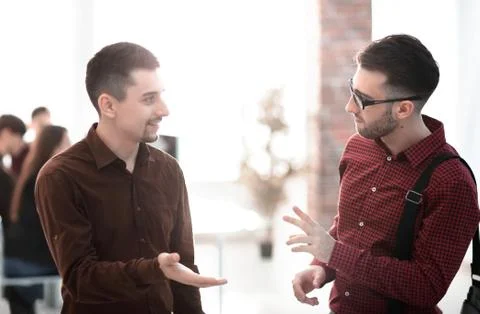 Two colleagues talking in office Stock Photos