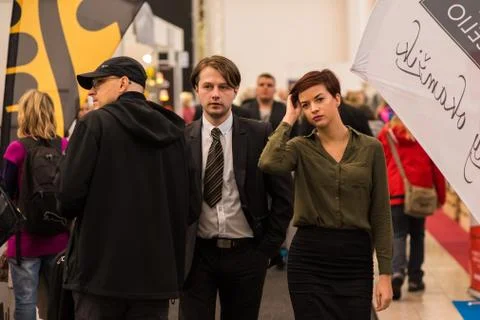 Two colleagues talking while walking at the convention trade center in Brno.  Stock Photos