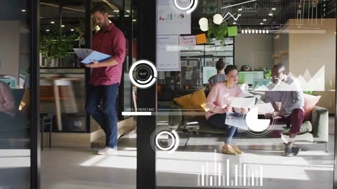 Two colleagues tapping laptop and flipping reports through glass, showing data Stock Footage 333553277
