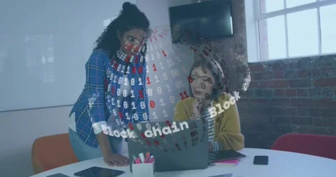 Two colleagues typing and noting during blockchain sphere appearing on laptop Stock Footage 328589411