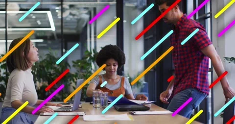 Two colleagues typing and reviewing folder in office as third entering pulling Stock Footage 327715005