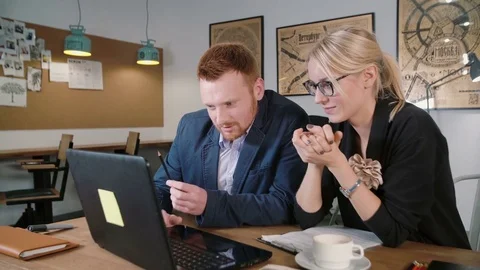 Two colleagues using digital display. Creative business small team meeting in Stock Footage 69750312