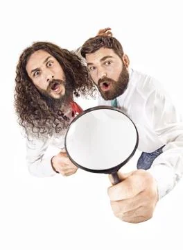 Two colleagues using a magnifying glass 스톡 사진