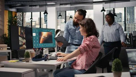 Two colleagues waiting for AI text to video generating on computer Stock-Fotos
