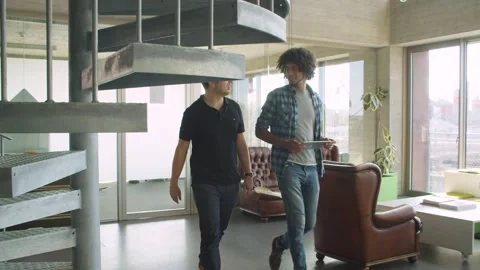 Two colleagues walking and talking  Stock Footage 144992136