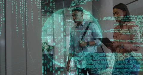 Two colleagues walking through office corridor, holding tablet showing tech code Stock Footage 307442963