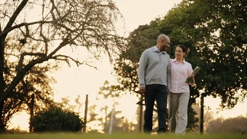 Two colleagues walking together in a park. Stock Footage 88406241