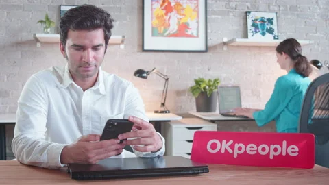 Two colleagues work and social distance while using their electronics, Stock Footage 137053511