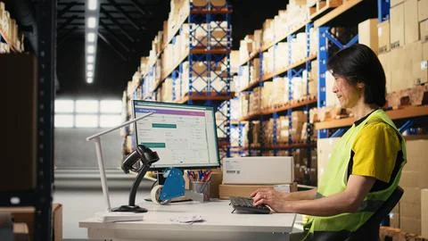 Two colleagues working on order processing in industrial warehouse space Foto stock