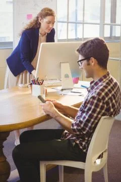Two colleagues working in the same office 스톡 사진