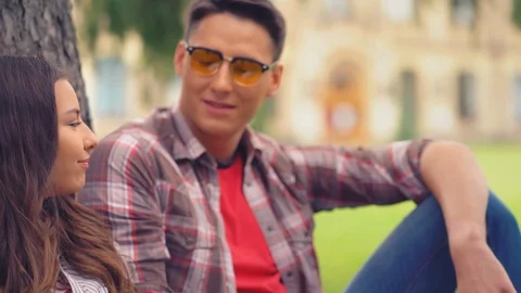 Two college students sitting under the tree. Stock Footage 127307619