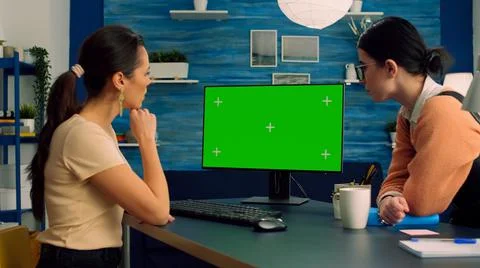 Two collegues working together on computer with mock up green screen chroma key Stock Photos