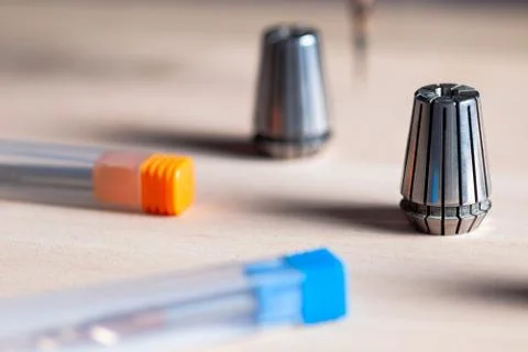 Two collets of a cnc machine, two cutters in a box Stock Photos