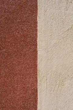 Two color plaster wall texture split vertically into brown and beige Фото