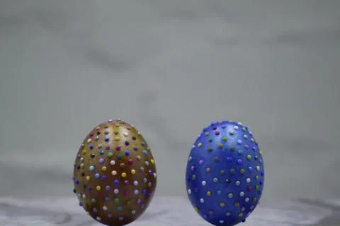 Two colored easter eggs on willow bouquet with pussy willows. Religious decor Stock Photos