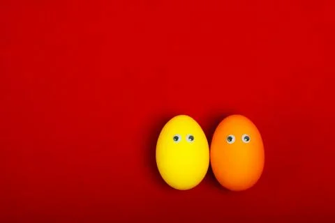 Two colored eggs with eyes Stock Photos