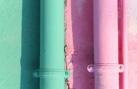 Two colored gutters on the painted wall of the house in Burano Island near Ve Фото