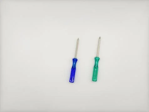 Two colored screwdrivers with plastic handles blue green left on white Stock Photos