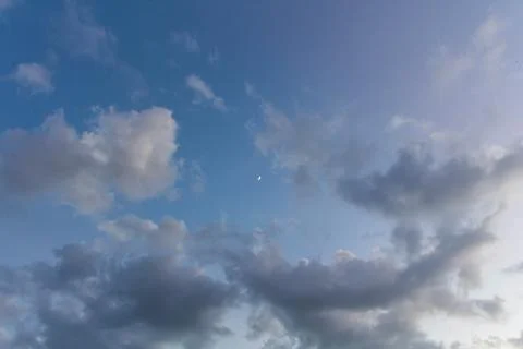 Two-colored sky, blue left and right-lighter purple, and a moon in the middle Stock Photos