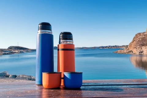 Two colored thermos Stock Photos