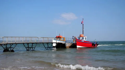 Two colorful boats moored to movable pier Vídeos de archivo 149727077