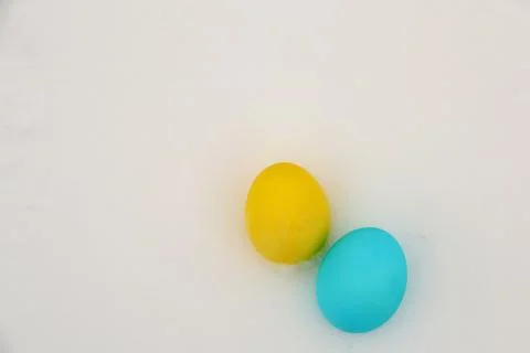 Two colorful eggs placed on light background during Easter season celebration Stock Photos