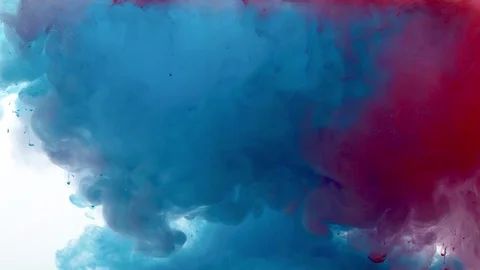 Two colors of paint dissolving in water Stock Footage 123692099