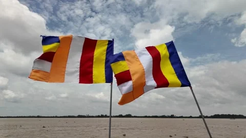 Two Colourful Buddhist Flags Waving in the Wind Against Cloudy Sky Over the Tien Stock Footage 313530177