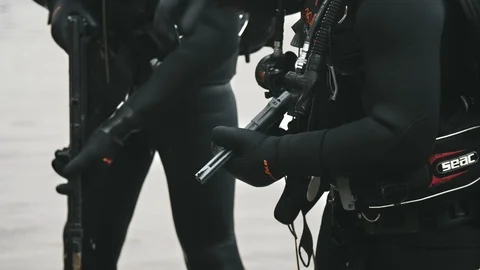 Two combat swimmers are standing on a riverbank keeping the weapon in hands Stock Footage 121904960