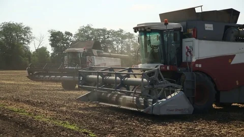 Two combines standing on a sloping field Stock Footage 82296268