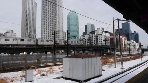 Two commuter trains heading in the same direction the #7 &amp; Metro North Stock Footage 148453017