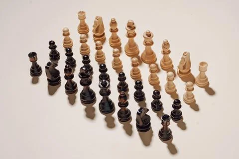 Two complete chess sets arranged in neat rows Stock Photos