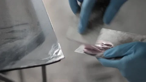 Two-component putty mixing before application to the metal part with the putty  Stock-Footage 130576159