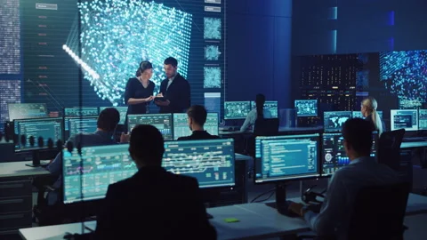Two Computer Data Science Engineers Work with Tablet in Control Room Stock Footage 135925954
